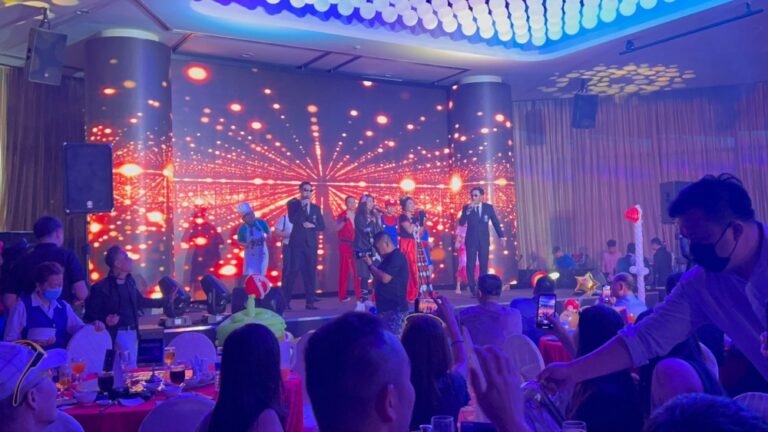 Group performance on stage with lively crowd