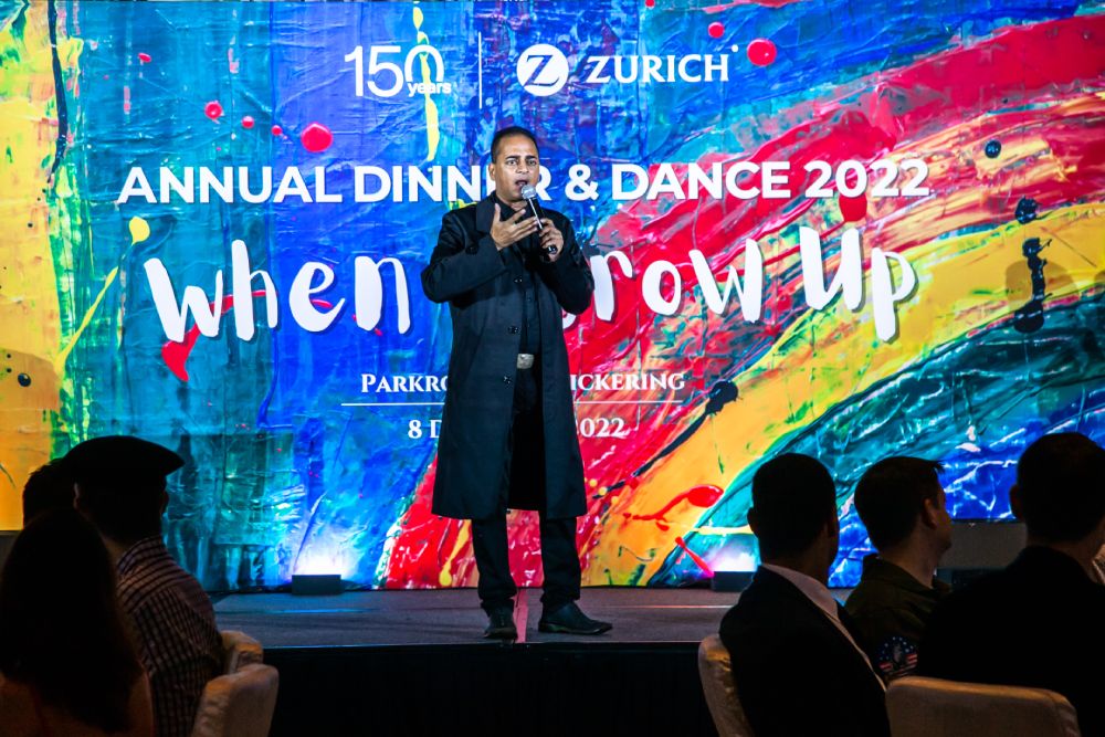 Man speaking on stage at company dinner